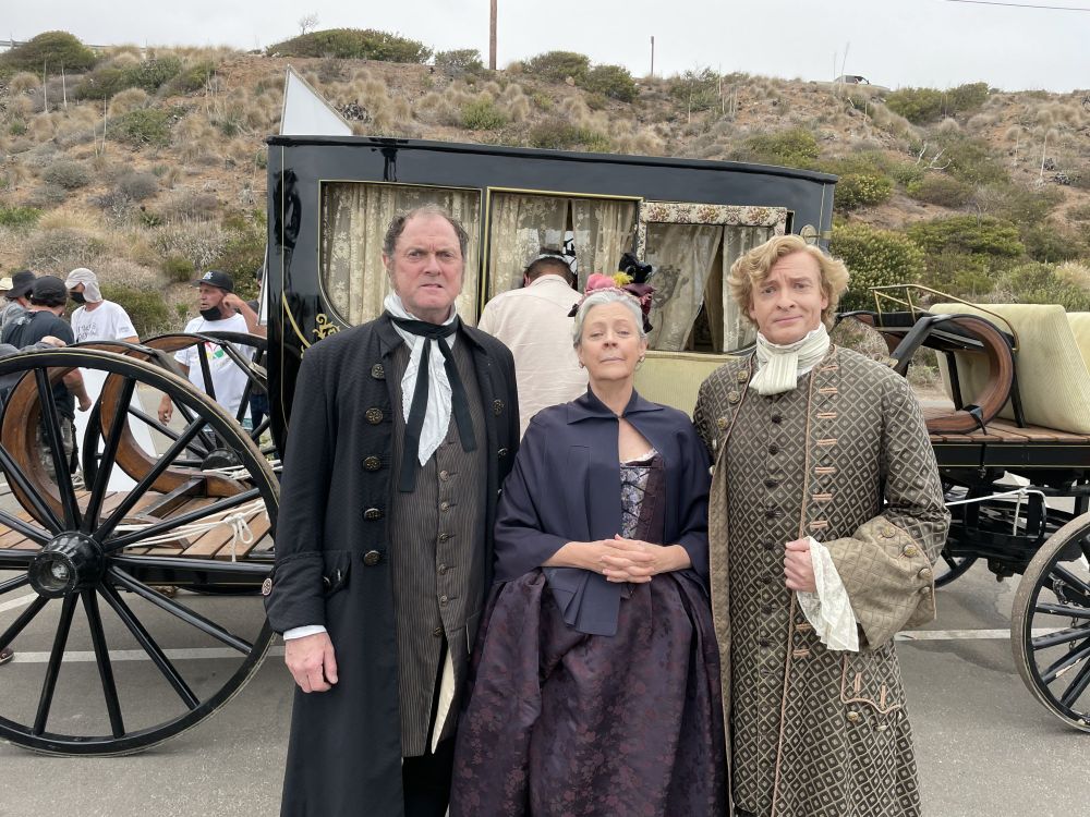Boris McGiver as Father Bonnet, Roslyn Gentle as Mother Bonnet, and Rhys Darby as Stede Bonnet. The carriage is in the background. Photo taken during the filming of Our Flag Means Death season 1 episode 4, Discomfort in a Married State. #OFMD