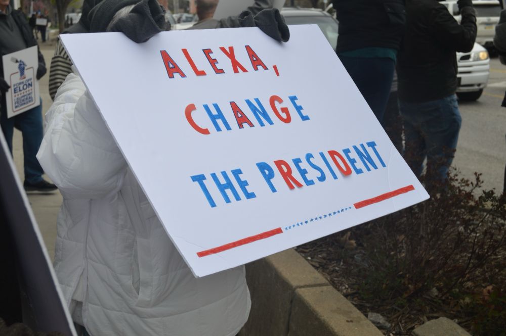 Close up of a sign reading, “Alexa, Change the President” at the #HANDSOFF demonstration in Lawrence, Ks