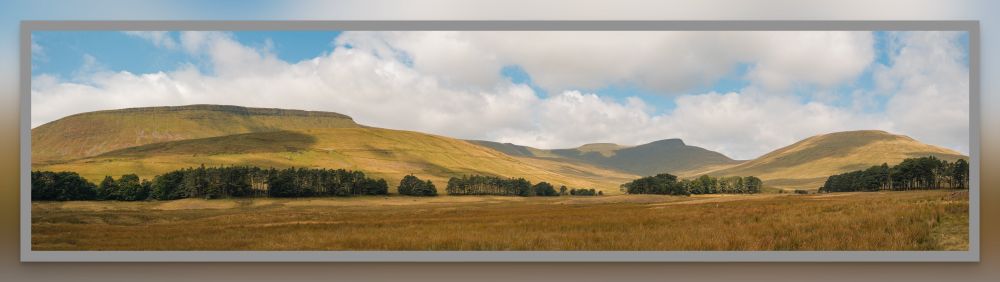 This is a photo of the eastern side of Craig-Gwaun-Taf ridge and the sound side of Pen-y-Fan, the highest mountain in the Brecon Beacons.

This photo is taken from the dried-out bed of Upper Neuadd Reservoir, an old Victorian reservoir that Welsh Water has drained and left somewhat abandoned.