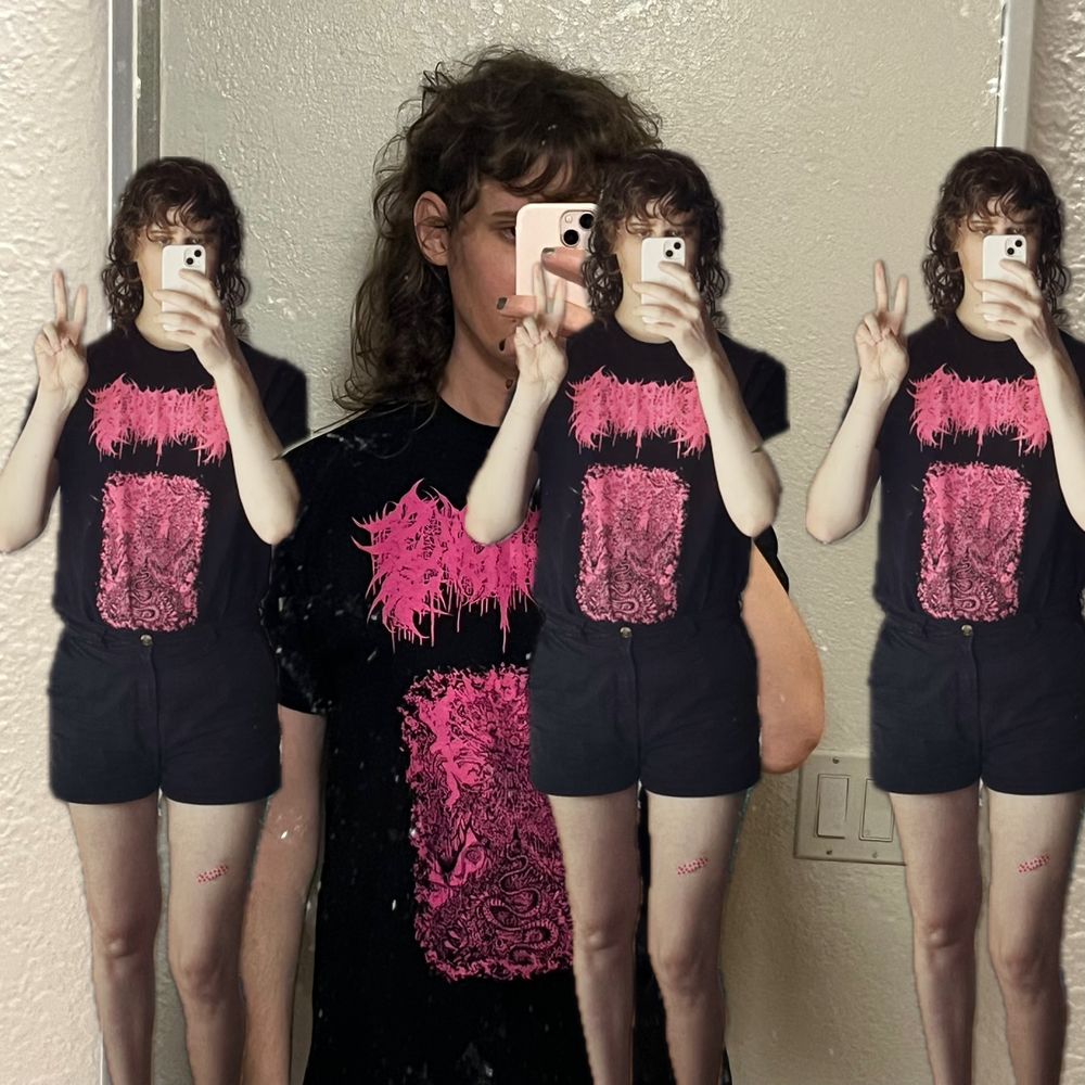 a mirror selfie with three cut out mirror selfies overlaid ontop. where a black metal shirt with bright pink graphics and small black shorts.
