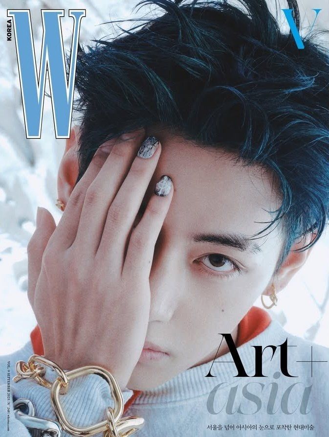 taehyung for w korea, with his hand over half of his face, two of hisnnails painted