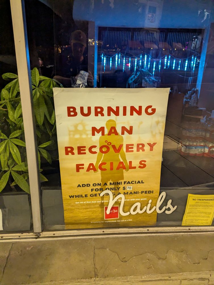 A sign in the Castro neighborhood of SF advertising "Burning Man Recovery Facials"