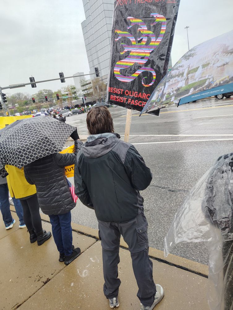 A sign with a rainbow hydra, resist fascism it reads 
