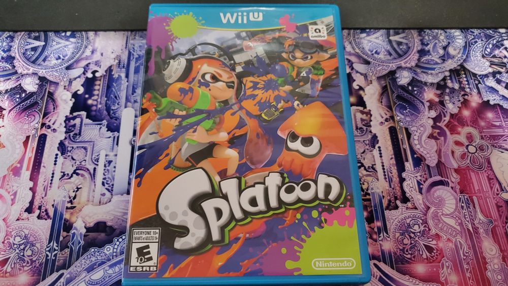 A copy of Splatoon sitting on a desk mat