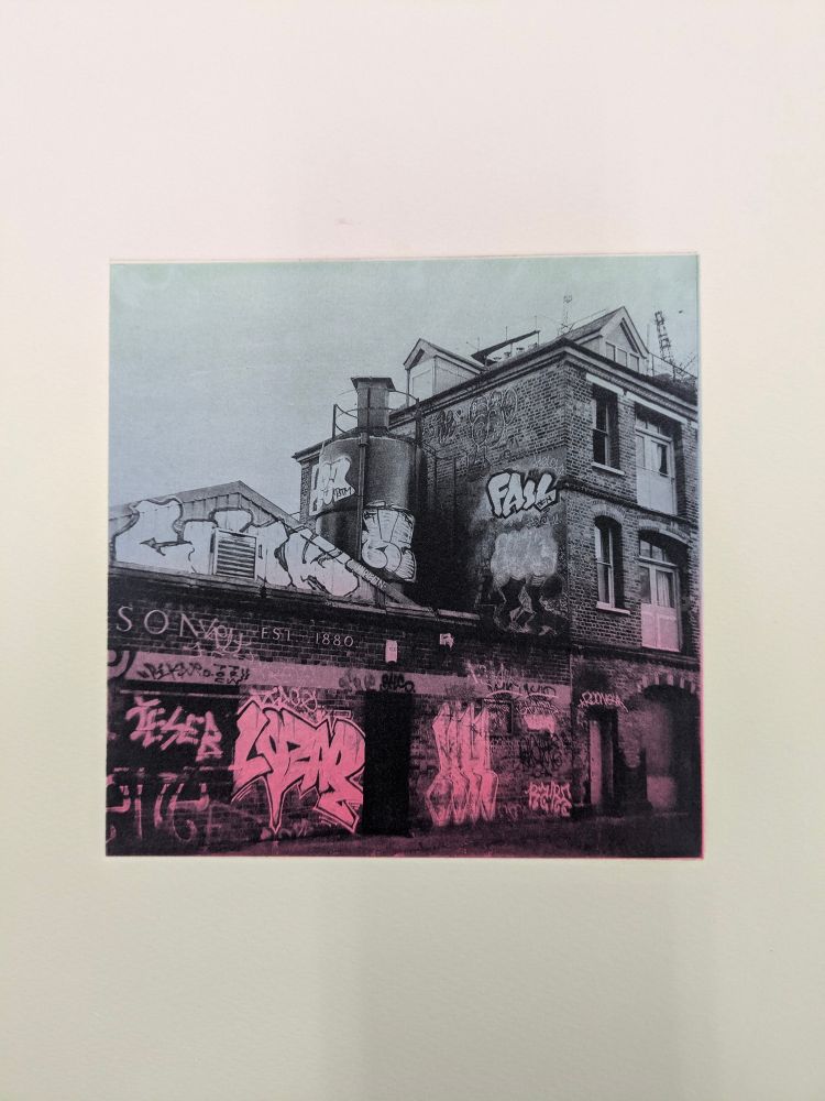 Foundry building covered in graffiti printed on colourful graduated paper