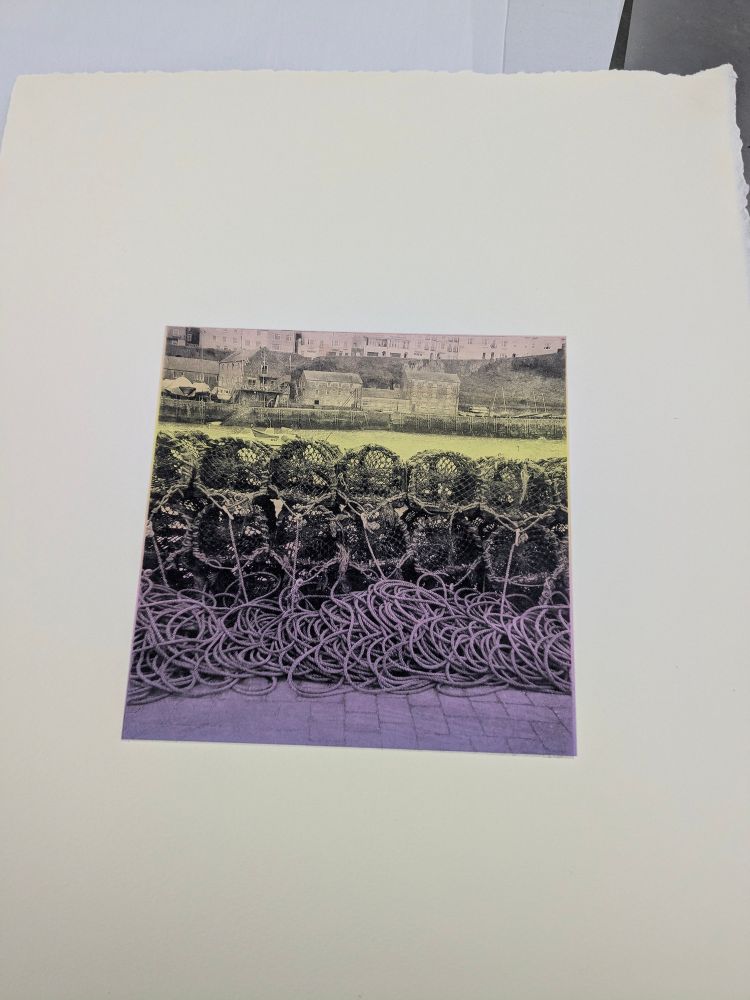 Crab pots and a bunch of rope on a dock, printed in black on colourful graduated paper