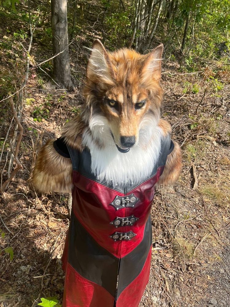 Read, stand in a forest, in a red leather coat, that's soaked in sweat.