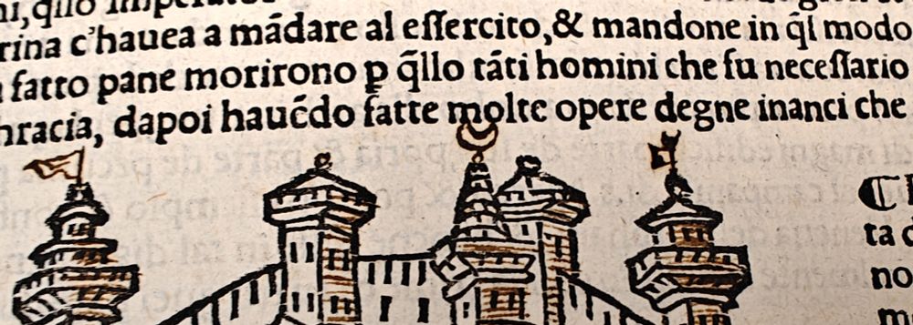 Detail of towers with added flags and a crescent.