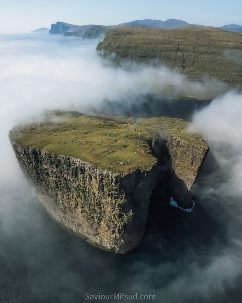 Trælanípan and the lake above the ocean also called Sørvagsvatn on Vágar, Faroe Islands. Ariel view with the fog surrounding the peak.