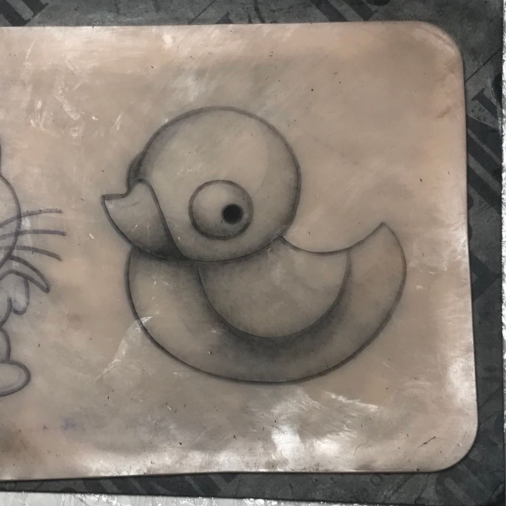 A closeup photo of a piece of Pound of Flesh silicone skin with a shaded cartoon illustration of a Battle Duck from Neopets.
