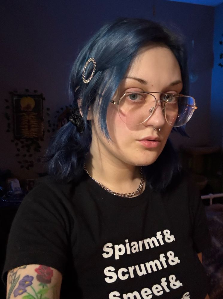 a selfie of me, blue hair in pigtails, oversized glasses, wearing a Game Grumps tshirt