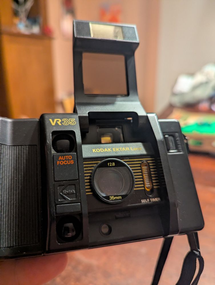 Kodak VR35 camera with its flash/lens cover open, you have never seen a camera that screams "I'm from the early 1980s" at such volume