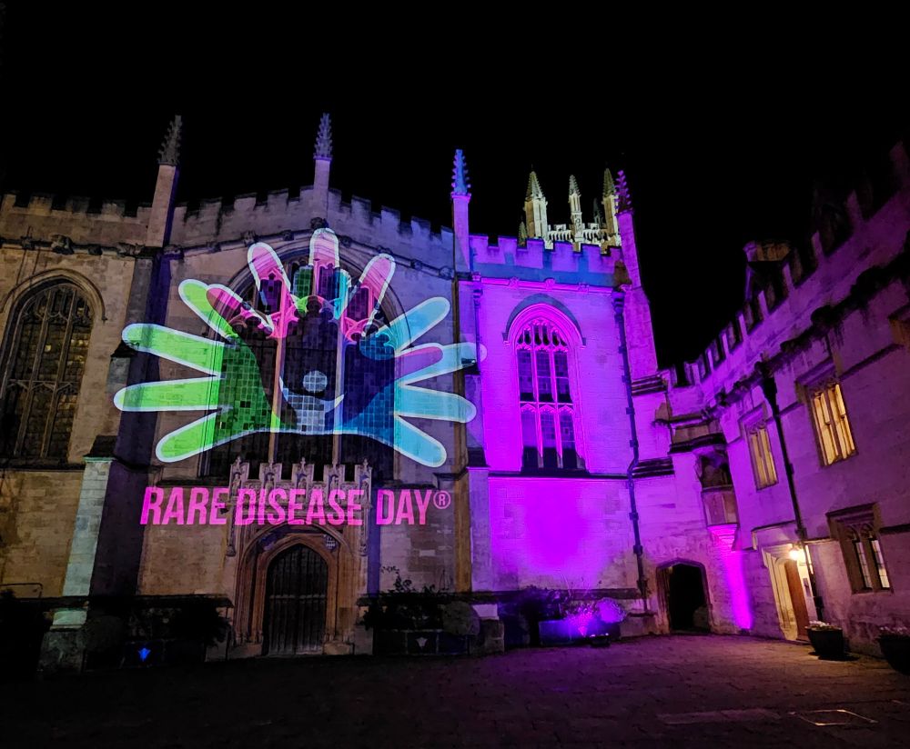Projection of the 'Rare Disease Day' logo on the facade of Magdalen College Chapel.