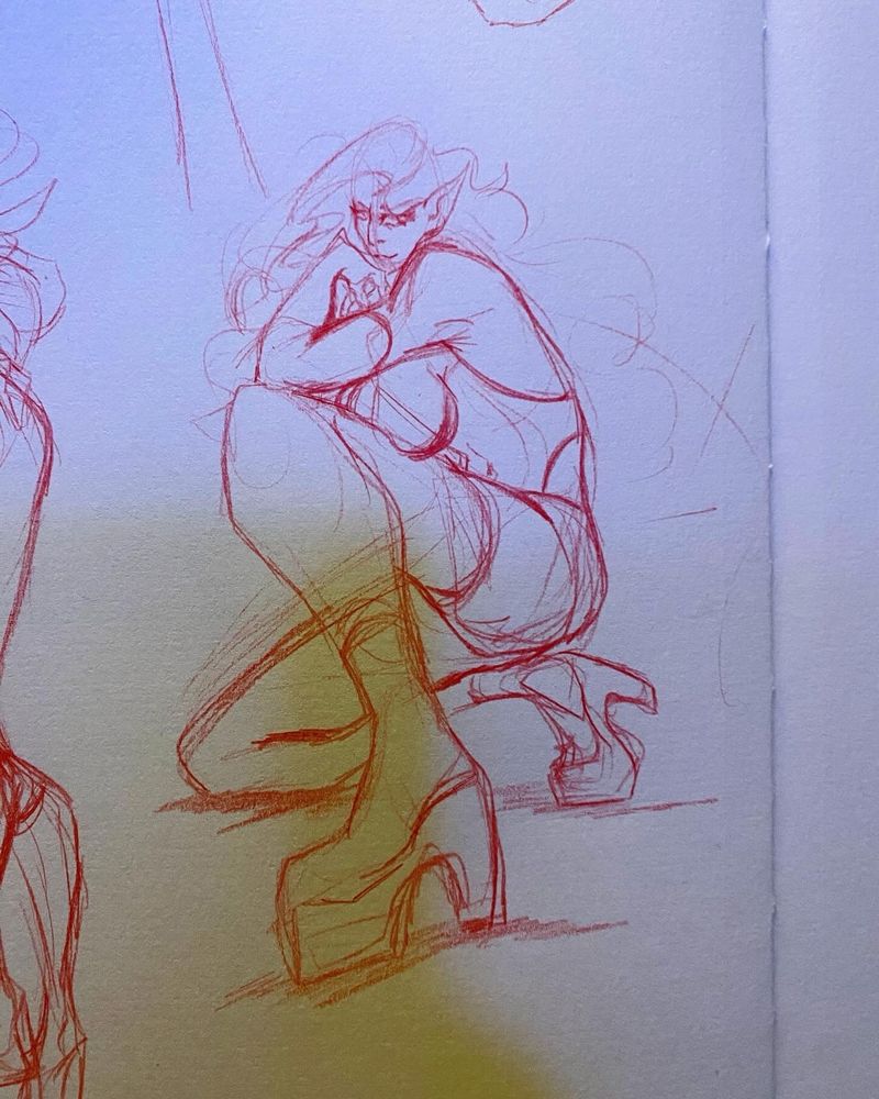 Sketch drawn in red on a sketchbook, the vampire lady in a dynamic pose, crouched and leaning forward with big boots and simple clothing. Her wings are not drawn this time