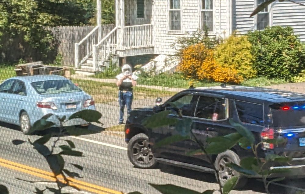 Police SUV and some kind of helmeted person