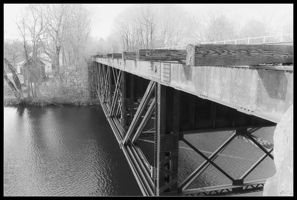 Black and white infrared of an old railroad bridge. Interestingly one half is still in use, and the other half is aging away. I wonder if it will be retrofitted. 

Accompanied by a passage from Jack Kerouac's book "On the Road."

"...the only people for me are the mad ones, the ones who are mad to live, mad to talk, mad to be saved, desirous of everything at the same time, the ones who never yawn or say a commonplace thing..."