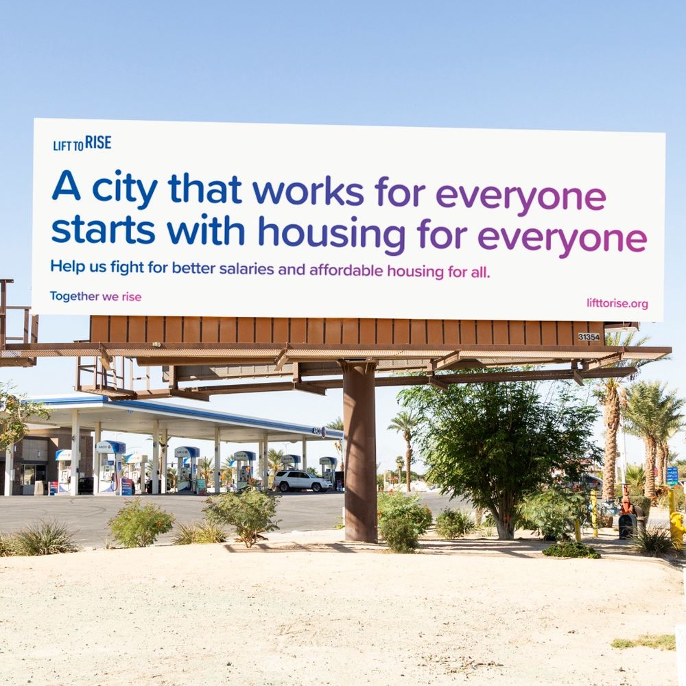 Billboard that reads “A city that works for everyone starts with housing for everyone. Hell is fight for better salaries and affordable housing for all.” Together we rise. Visited lifttorise.org. 