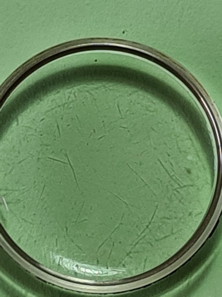 Highly scratched watch crystal