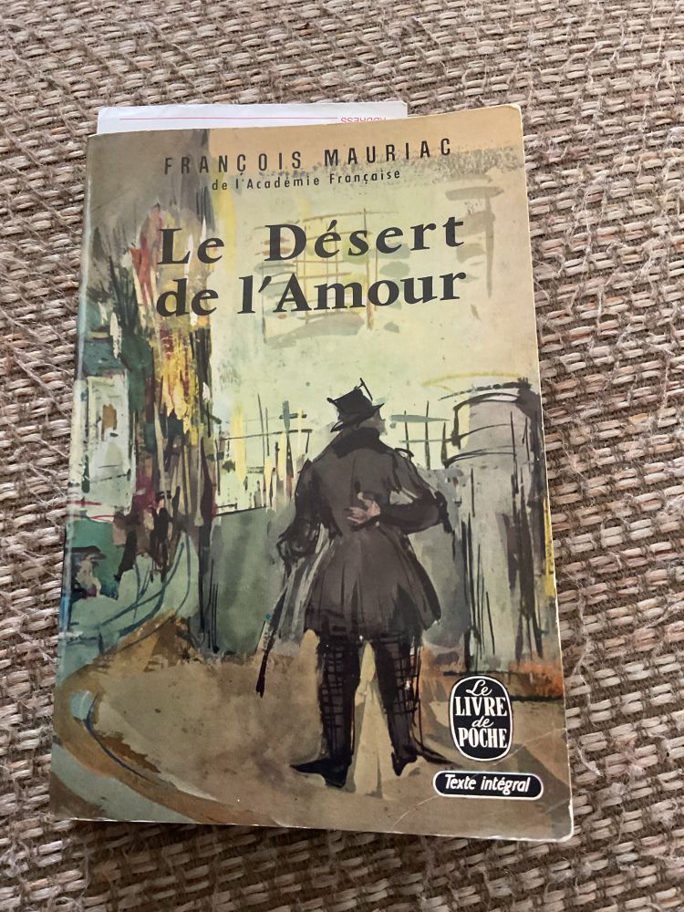 Cover of a Livre de Poche edition of Francois Mauriac’s Le Desert de l’Amour featuring an impressionistic image of a man with top hat and cane walking through a city. 