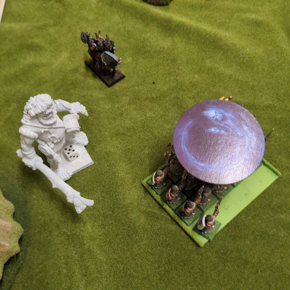 My (again) unpainted (sorry about that, I'm painting as fast as I can, which is admittedly not very fast, but I'm trying) giant watched on with disappointment on his face as the chaos sorcerer managed to suck the souls out of a bunch of elves he was planning on jumping up and down on. Luckily there were a few left over for him to get some trampolining in.