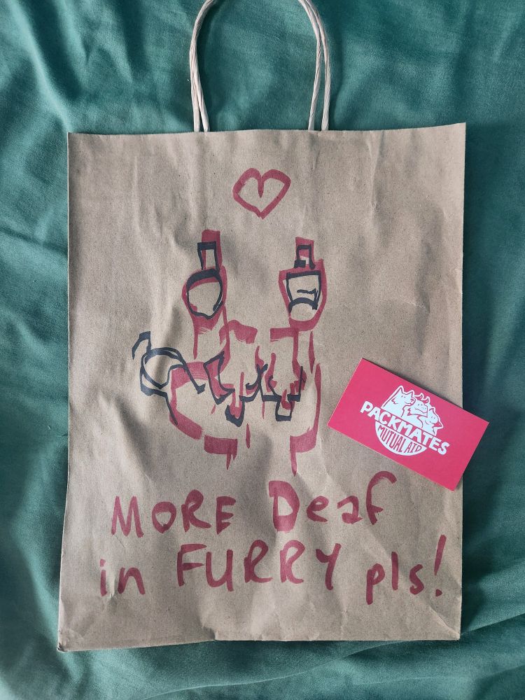 The store bag says "More deaf in furry pls" - the artist drew it to show support for the Deaf community.