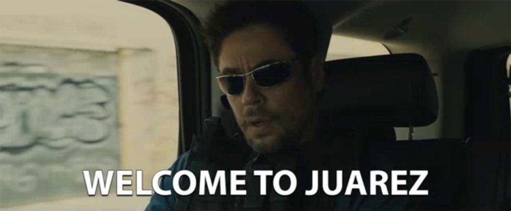 a man wearing sunglasses is sitting in a car with the words welcome to juarez below him