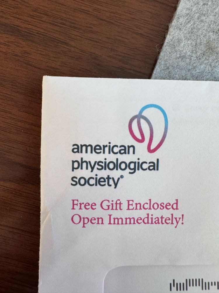 An envelope from the American Physiological Society that says “Free gift enclosed! Open immediately!”