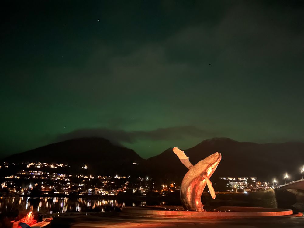 A faint green glow around the illuminated whale statue in Juneau, Alaska 