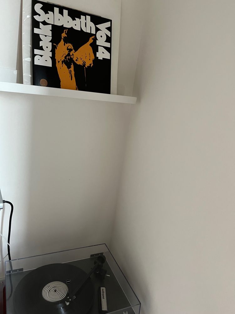 Record player with vinyl copy of Black Sabbath - Vol. 4 on a shelf above player