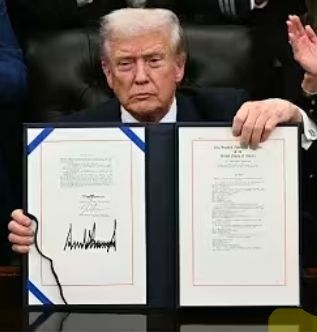 Donald Trump, pictured with the legal document reopening the government and looking incredibly bitter about it and possibly (hopefully) suffering from Bell's Palsy