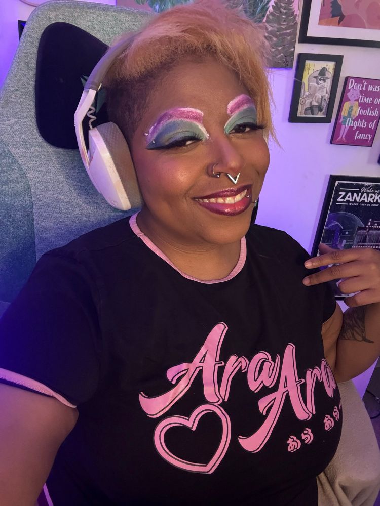 Bianca is smiling with bi pride eye make up