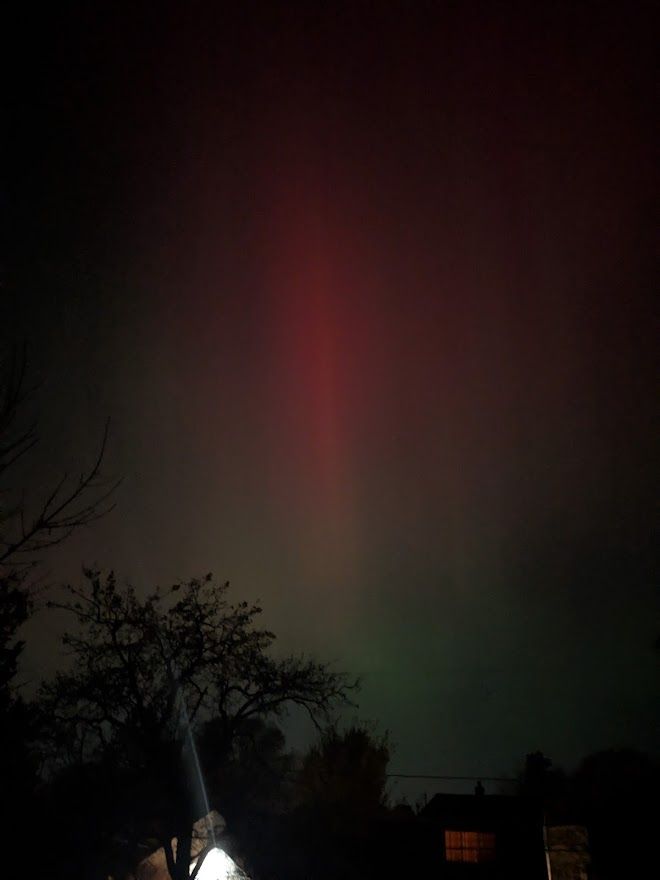 A vivid pink streak in the dark night sky.