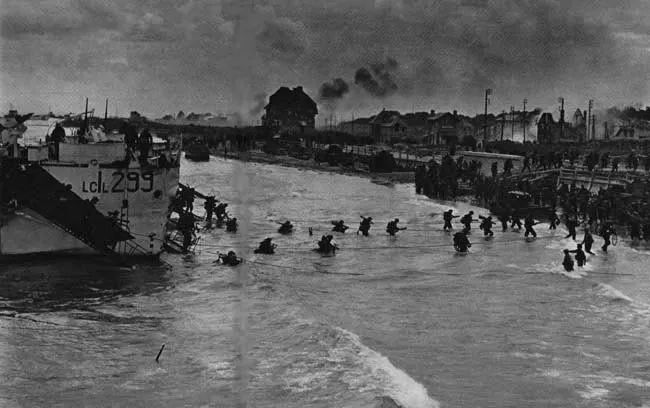 Canada lands at Juno Beach, Normandy June 6th, 1944. 
Thank you. Merci.  

B&W photo of Canadian troops leaving ship and wading through water towards Juno Beach