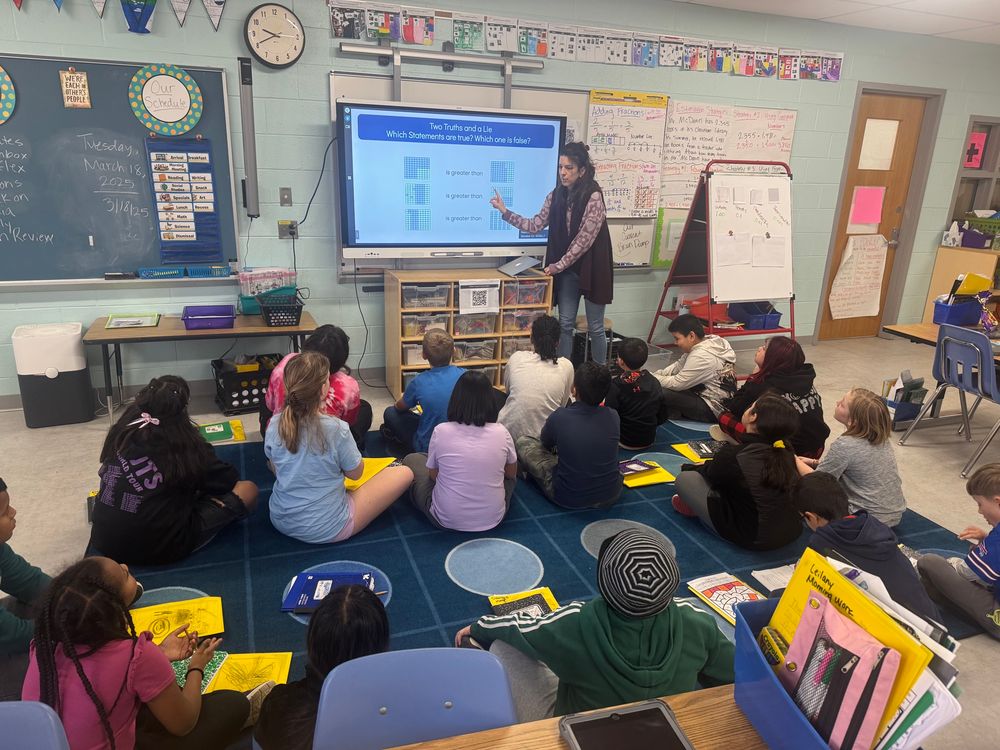 Teacher at board explaining “Two Truths and a Lie” number sense routine!