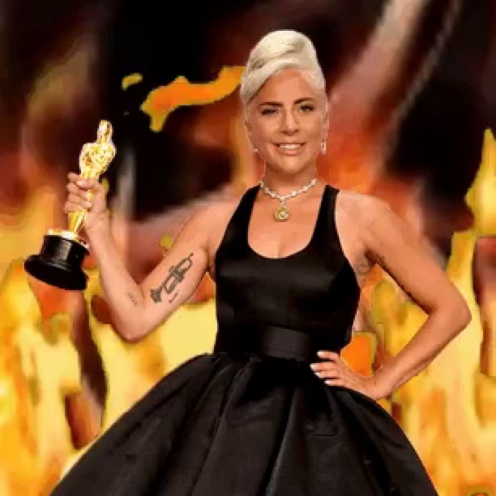 lady gaga in a black dress is holding an oscar statue