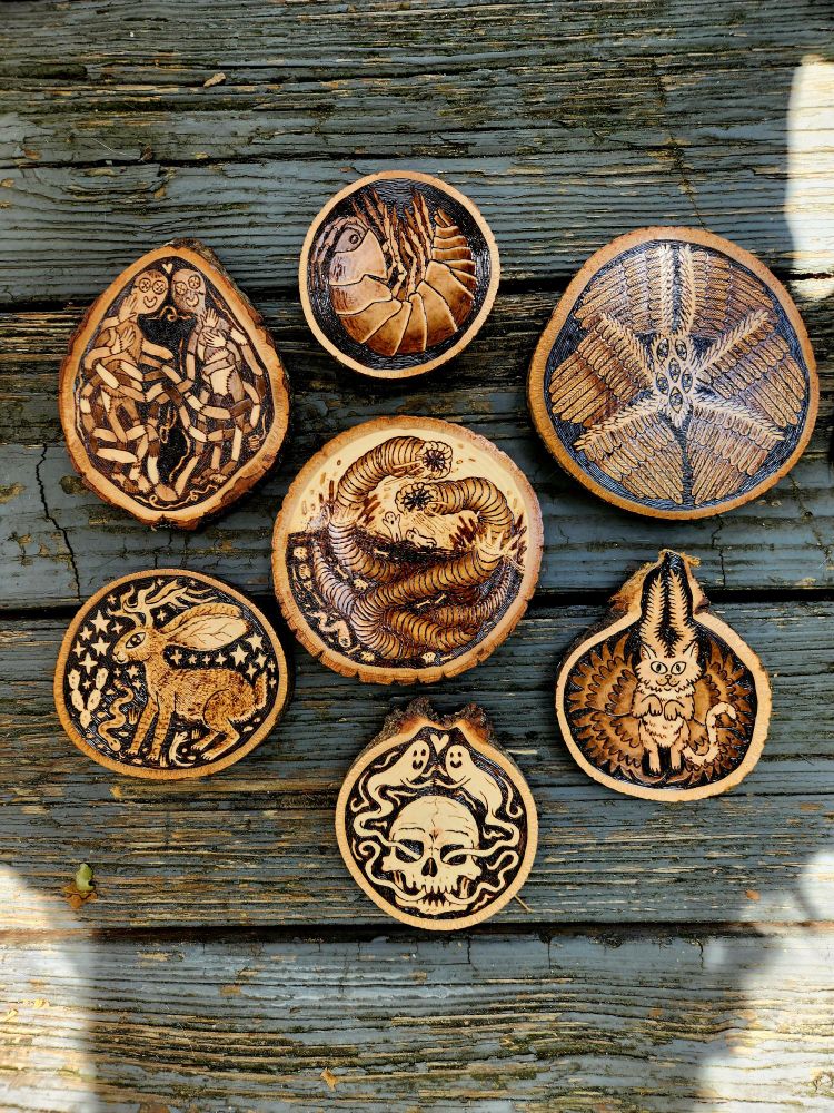 Shows seven woodburned pieces.