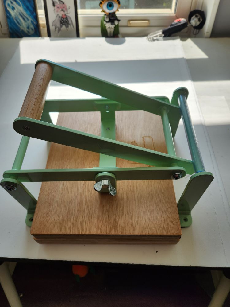 A pressure printing press sits on a table