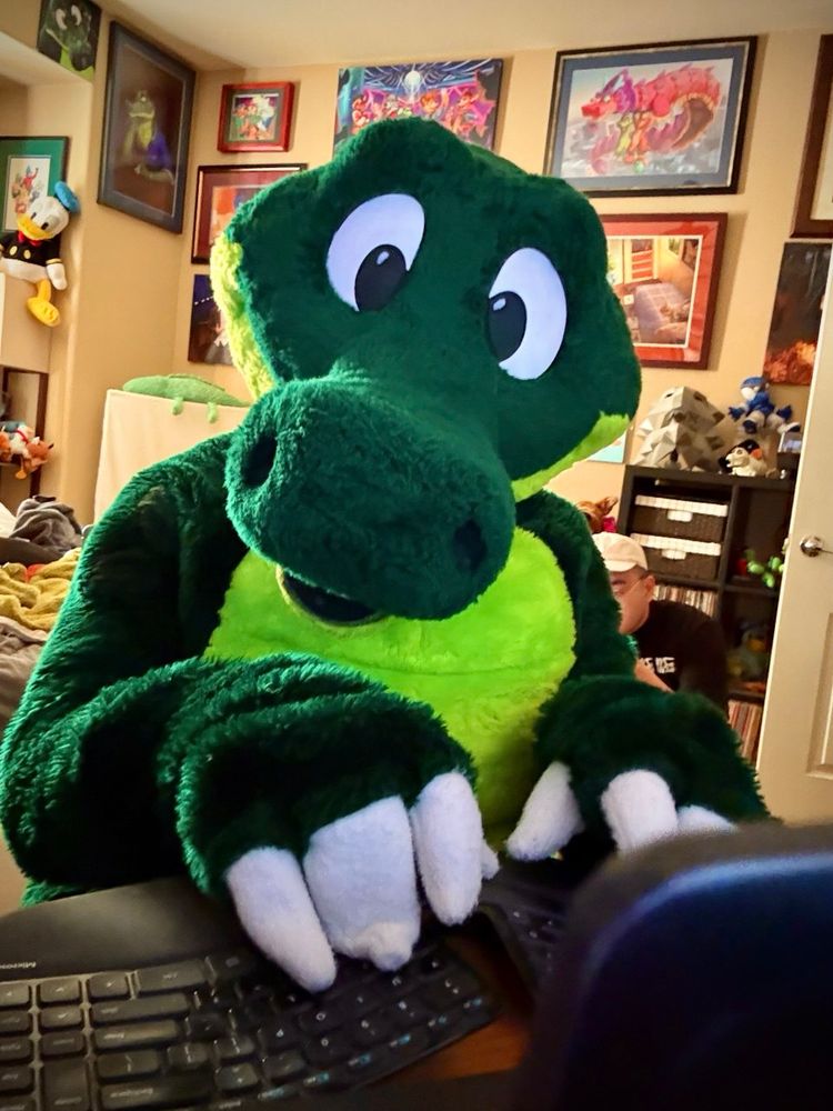 photo of Croc in his room, typing on a black keyboard at his desk