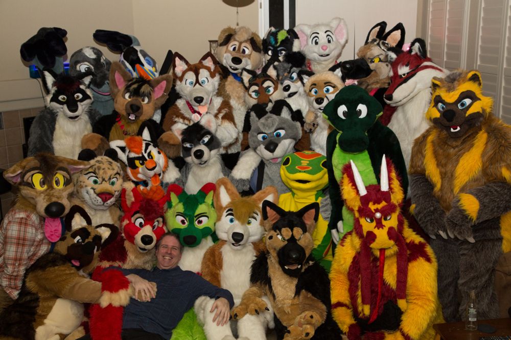 photo, a smiling Croc (person) surrounded by countless other fuzzy animals on his 42nd birthday