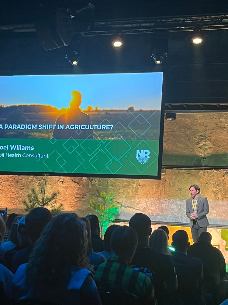 Joel Williams presenting on the main stage at the conference