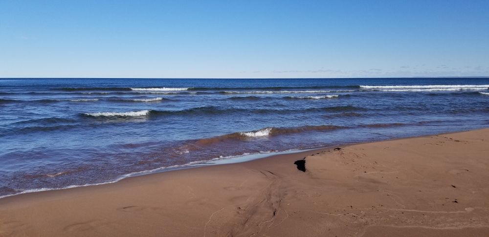 A sunny day spent watching small Lake Superior waves crash on the beach in chilly Duluth