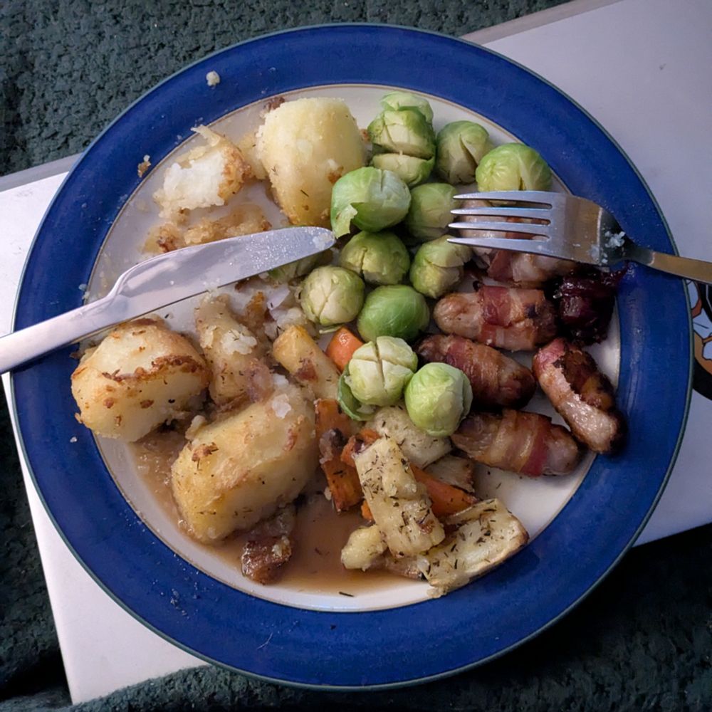 Christmas dinner, prioritised! Many roast potatoes, parsnips, carrots, load of sprouts, pigs in blankets, cranberry sauce, gravy. Needs better gravy and maybe some stuffing, otherwise no notes. Also I obviously couldn't wait to take this photo as I've clearly already got into the roasties.