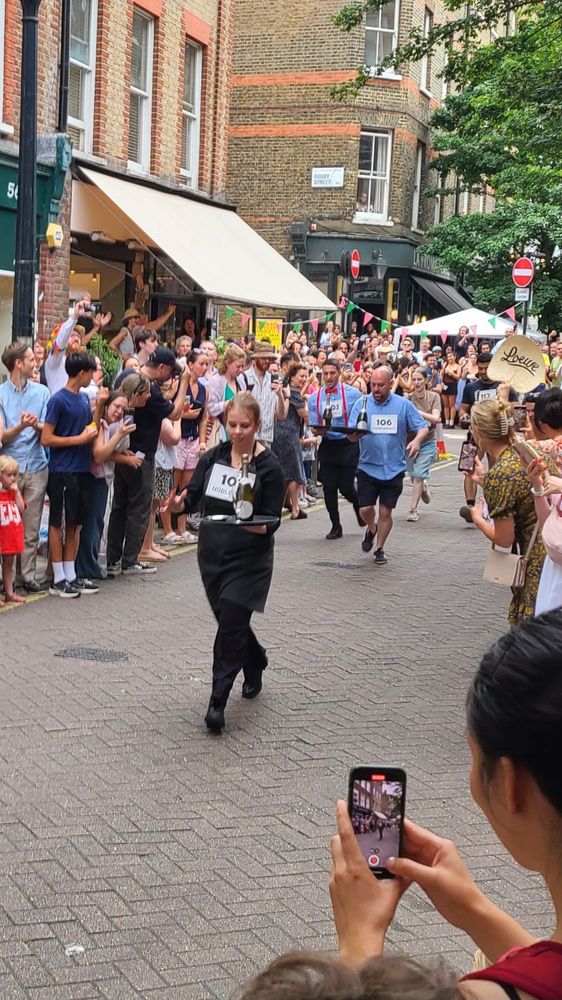 And they're off! Waiters carrying trays of glassware in a footrace along Lamb's Conduit.