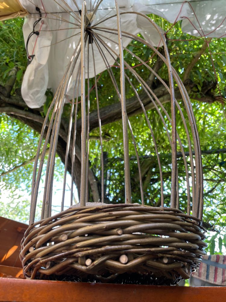 Progress shot of my willow basket. I’ve added vertical ribs to the edges and a concrete brick at the base for stability 