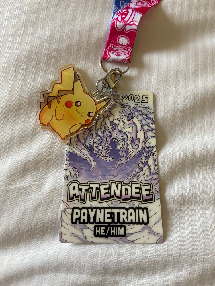 Summer Games Done Quick 2025 badge pictured with a fat Pikachu clipped to the badge’s lanyard