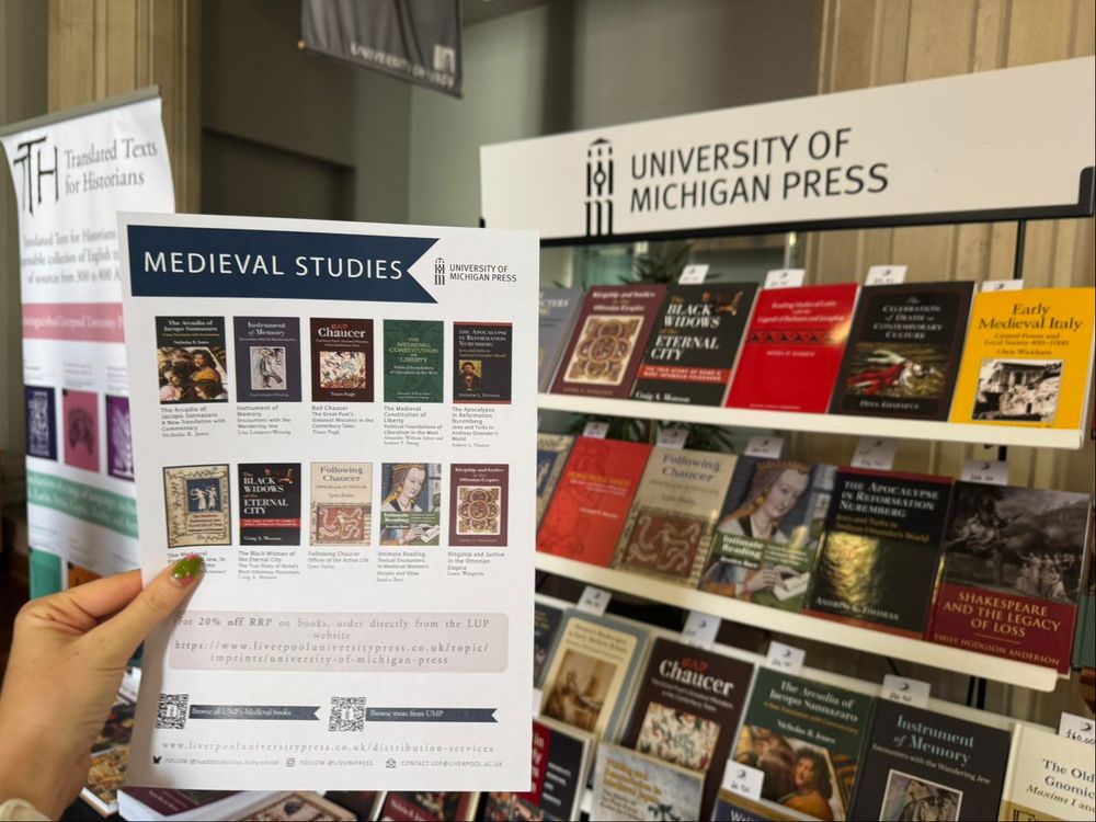 Display of Medieval books from University of Michigan Press with a printed flyer in the foreground with more information. 