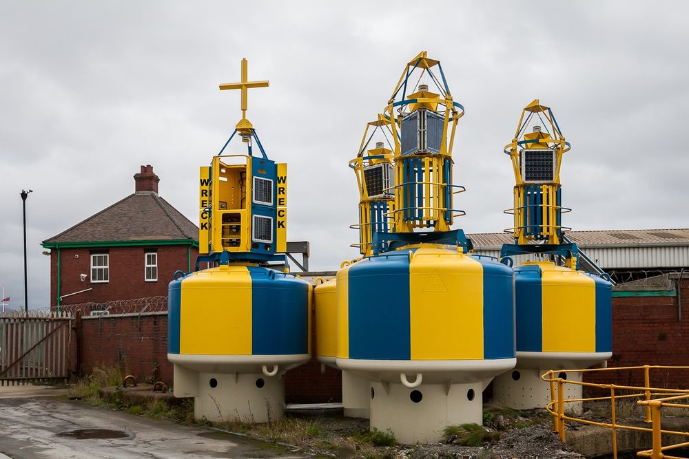 Blue and yellow striped buoys stacked up in Harwich. That must have been quite some milkshake.