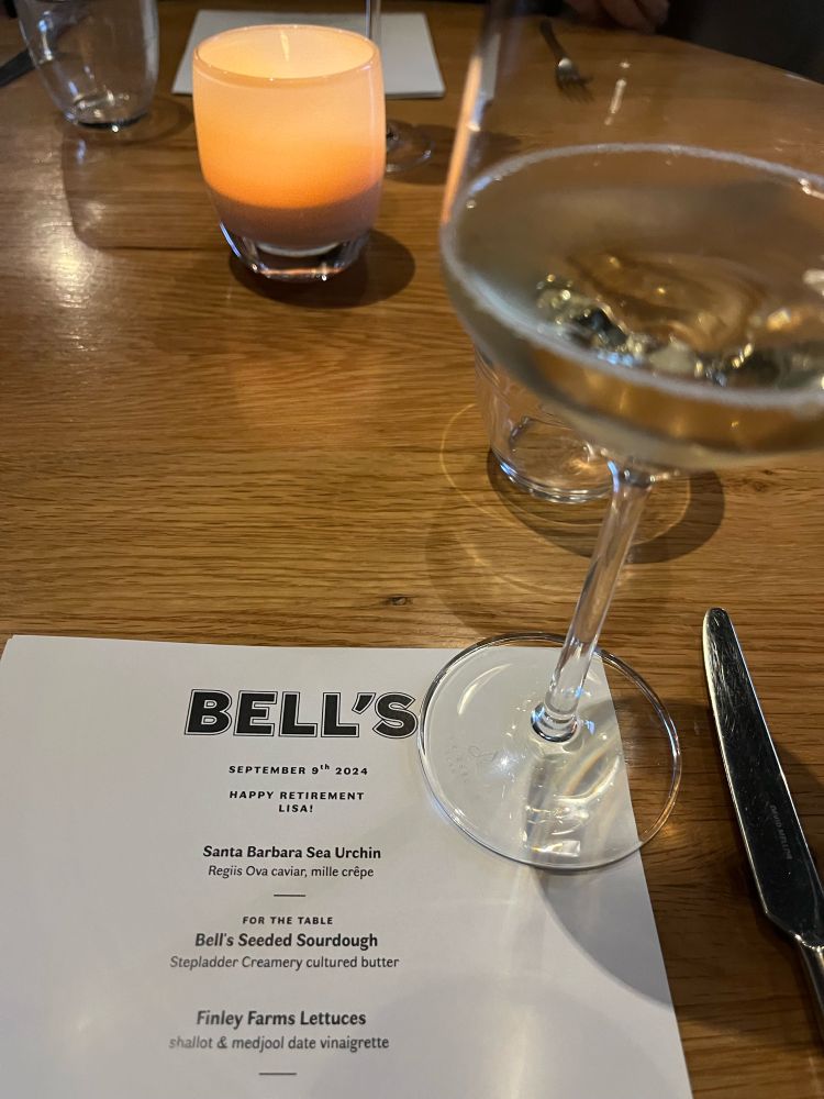 Photo of a dinner menu and a glass of sparkling wine.