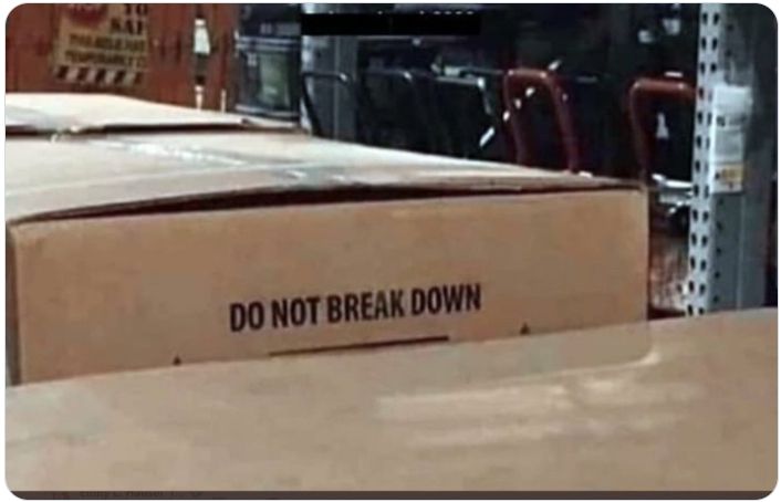 packing boxes in warehouse setting, one slightly higher than the other, the words "DO NOT BREAK DOWN" can be seen on it