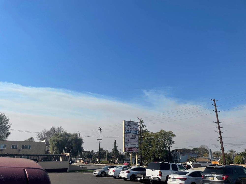 Smoke from fires seen moving south covering the skies of Los Angeles county 
